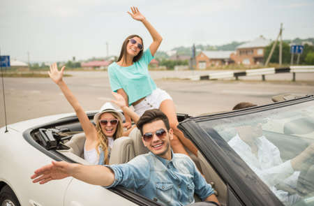Happy friends driving in the cabriolet and having fun.の写真素材