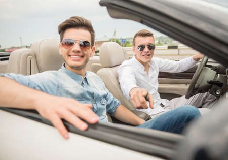 Handsome boys in the cabriolet looking at camera and smiling.の写真素材