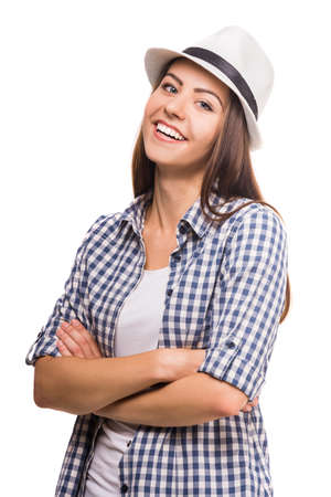 Portrait of flirty girl dressed casual smiling at camera on white background.の写真素材