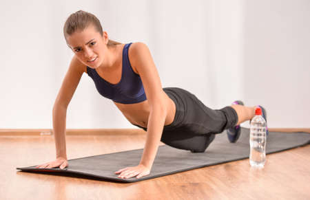 Young sadness woman is doing morning exercises. Concept of diet.の写真素材