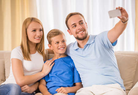 Happy family making selfie together at home.の写真素材