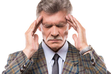 Portrait of senior man is suffering from headache.の写真素材