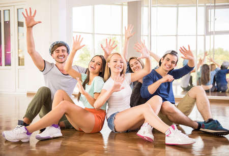 Fitness dance studio class. Group of people are posing in dance studio.の写真素材