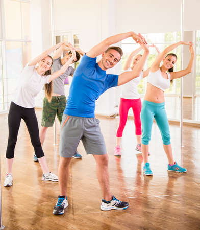 Fitness dance studio class. Group of people are exercising in dance studio.の写真素材