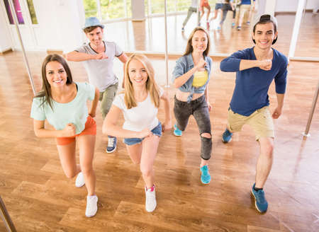 Young dancing people in gym during exercise dancer workout training with happy fresh energy.の写真素材