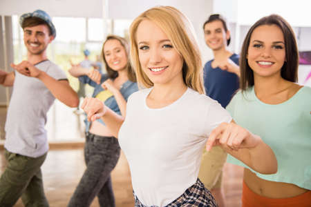 Young dancing people in gym during exercise dancer workout training with happy fresh energy.の写真素材
