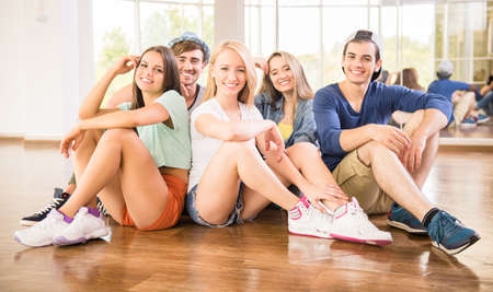 Fitness dance studio class. Group of people are posing in dance studio.の写真素材