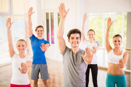 Fitness dance studio class. Group of people are exercising in dance studio.の写真素材