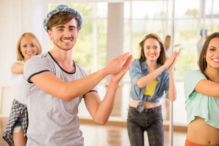 Young dancing people in gym during exercise dancer workout training with happy fresh energy.の写真素材