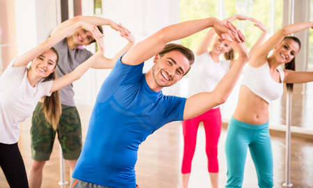 Fitness dance studio class. Group of people are exercising in dance studio.の写真素材