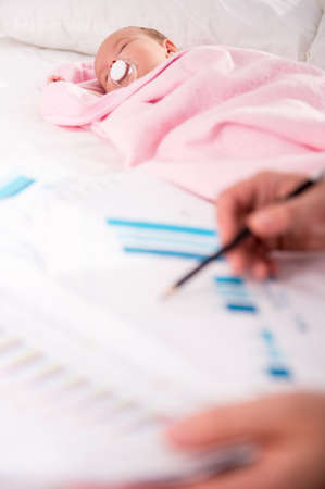 Portrait of young happy father with a baby at homeの写真素材