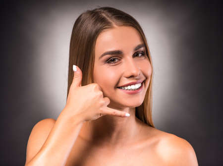 Portrait of a young, beautiful, emotional woman on a dark background. Studio shootの写真素材