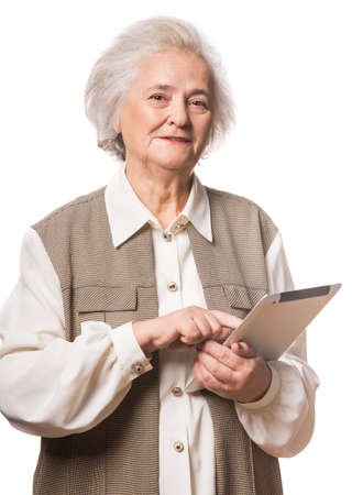 Senior woman using tablet isolated on white backgroundの写真素材