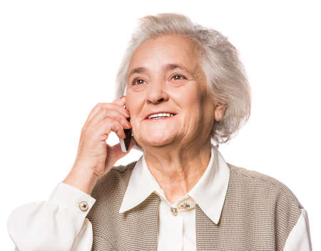 Senior woman using phone isolated on a white backgroundの写真素材