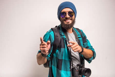 Young cheerful photographer with beard, while working in studioの写真素材