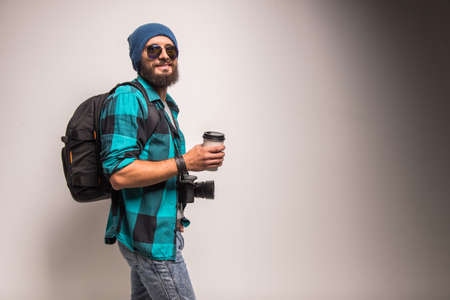Young cheerful photographer with beard, while working in studioの写真素材