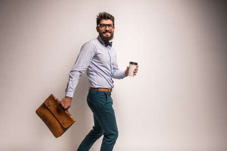 Portrait of a young businessman with beard on a gray background. Studio shootingの写真素材