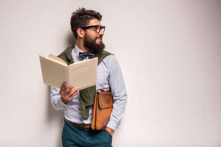 Portrait of a young businessman with beard on a gray background. Studio shootingの写真素材