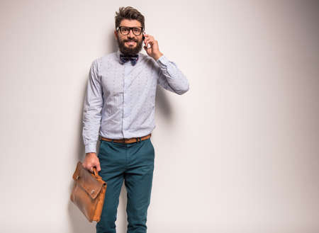 Portrait of a young businessman with beard on a gray background. Studio shootingの写真素材