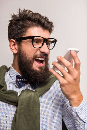 Portrait of a young businessman with beard on a gray background. Studio shootingの写真素材