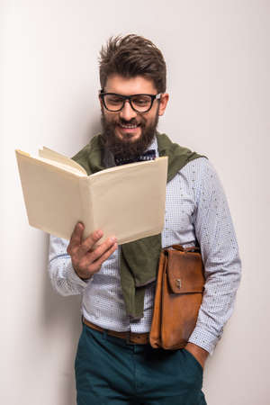 Portrait of a young businessman with beard on a gray background. Studio shootingの写真素材