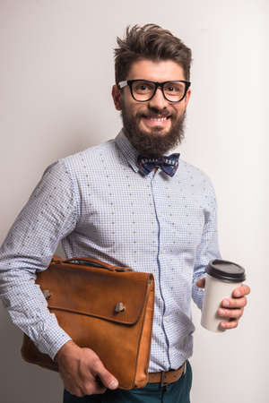 Portrait of a young businessman with beard on a gray background. Studio shootingの写真素材