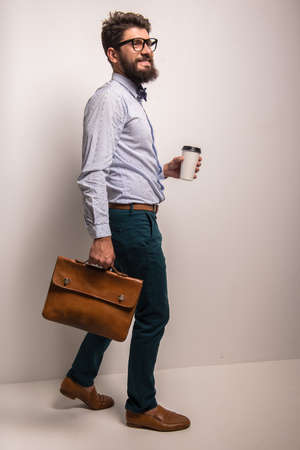 Portrait of a young businessman with beard on a gray background. Studio shootingの写真素材
