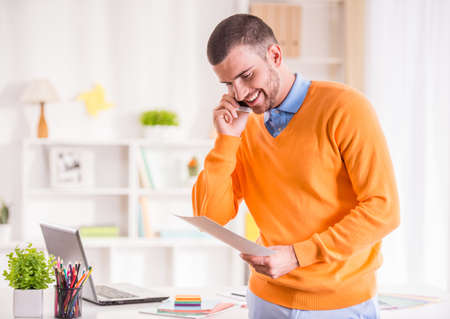 Portrait of a young businessman designer working in officeの写真素材