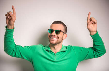 Portrait of fun man on a gray background. Studio shootingの写真素材