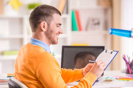 Portrait of a young businessman designer working in officeの写真素材