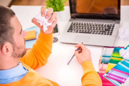 Portrait of a young businessman designer working in officeの写真素材