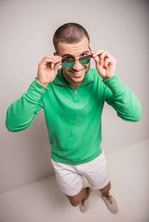 Portrait of fun man on a gray background. Studio shootingの写真素材