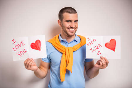 Portrait of a young man with a card for his girlfriendの写真素材