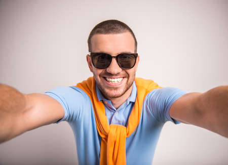Portrait of fun man on a gray background. Studio shootingの写真素材
