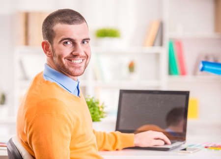 Portrait of a young businessman designer working in officeの写真素材