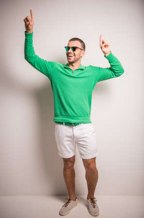 Portrait of fun man on a gray background. Studio shootingの写真素材