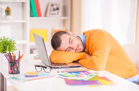 Portrait of a young businessman designer working in officeの写真素材