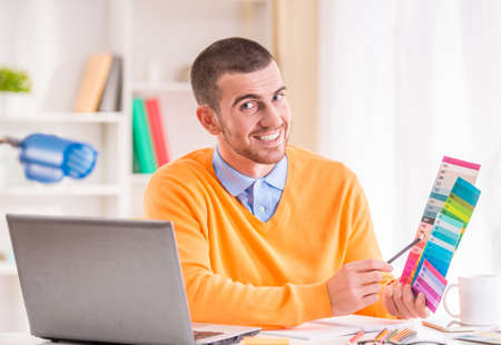 Portrait of a young businessman designer working in officeの写真素材