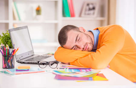 Portrait of a young businessman designer working in officeの写真素材