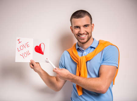 Portrait of a young man with a card for his girlfriendの写真素材