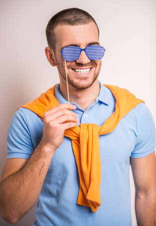Portrait of fun man on a gray background. Studio shootingの写真素材