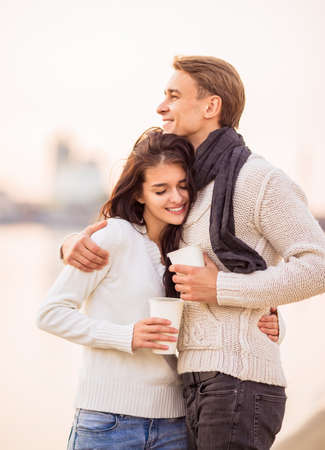 Loving young couple walk on the beach in autumnの写真素材