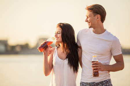 Loving young couple walk on the beach in summerの写真素材