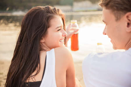 Loving young couple walk on the beach in summerの写真素材