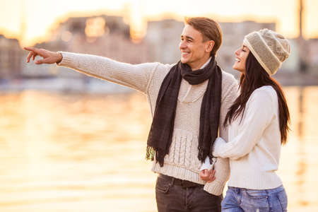 Loving young couple walk on the beach in autumnの写真素材