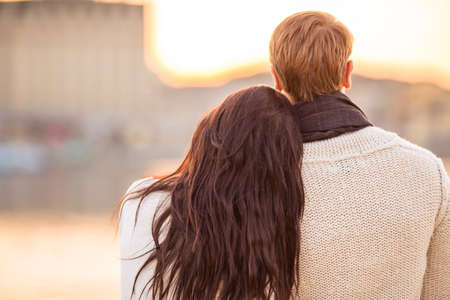 Loving young couple walk on the beach in autumnの写真素材