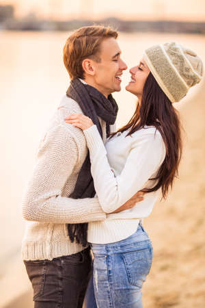 Loving young couple walk on the beach in autumnの写真素材