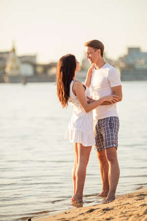 Loving young couple walk on the beach in summerの写真素材