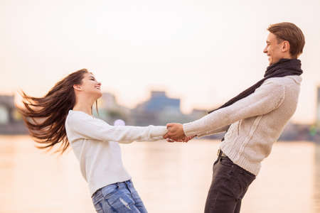 Loving young couple walk on the beach in autumnの写真素材