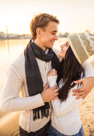 Loving young couple walk on the beach in autumnの写真素材